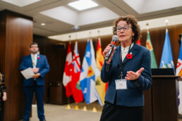 MP Louise Chabot speaks at the reception, with CCCE’s James Janeiro standing in the background