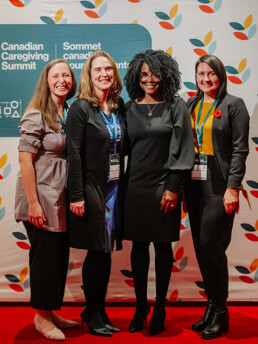 Dr. Heather Aldersey, Dr. Afolasade Fakolade and fellow attendees from Queen’s University posing in front of a step-repeat banner with the CCCE logo on it