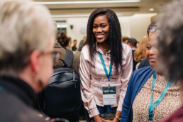 DSP Fellow Drucila Kakwerre smiles as she chats with other attendees at the reception