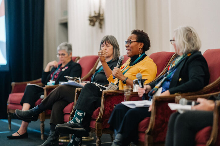 Side profile of CCCE's advisory council member Sherron Grant speaking during the panel on respite care. She is wearing dark green socks with the CCCE logo.
