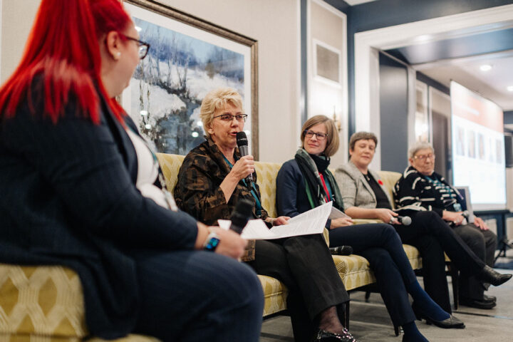 Speakers from the Helping in French panel on stage