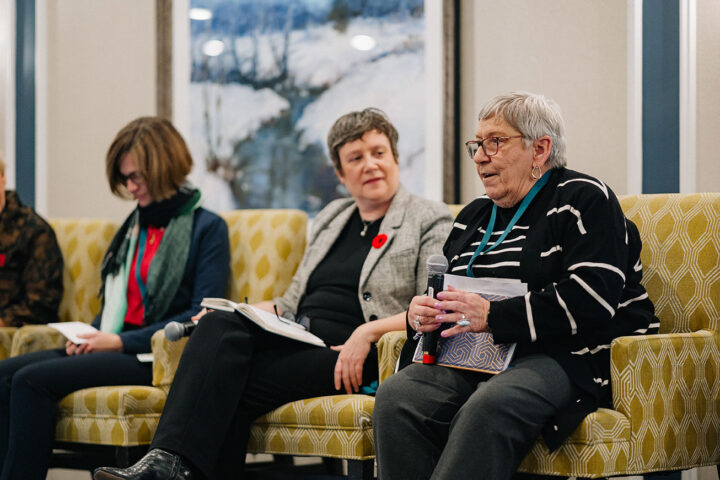 Speakers from the Helping in French panel on stage, with the focus on Norma Dube