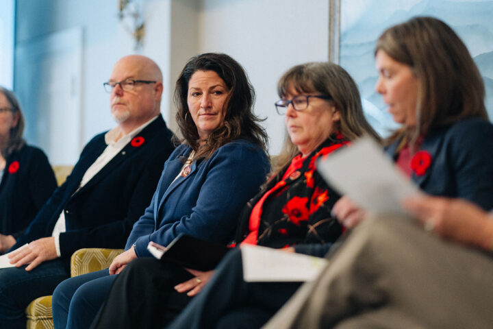 Speakers from the military and veteran caregiving panel on stage, with Dr. Heidi Cramm in focus