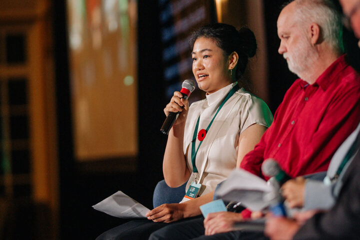 CBC journalist Catherine Zhu shares on stage, seated next to Andre Picard