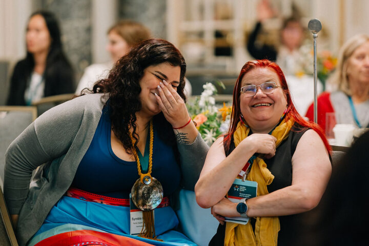 Attendees share a moment of laughter during a session.