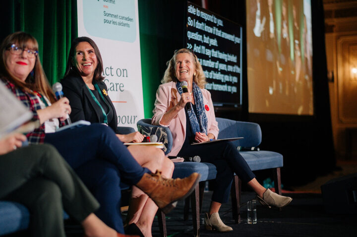 Former Ontario Premier Kathleen Wynne shares a moment of laughter on stage with fellow panelists