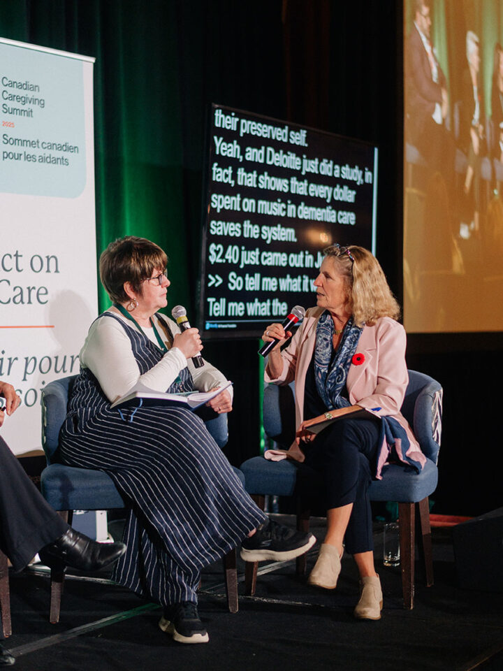 Bev Foster presents her group's idea to Kathleen Wynne during the advocacy workshop, with both of them seated on stage