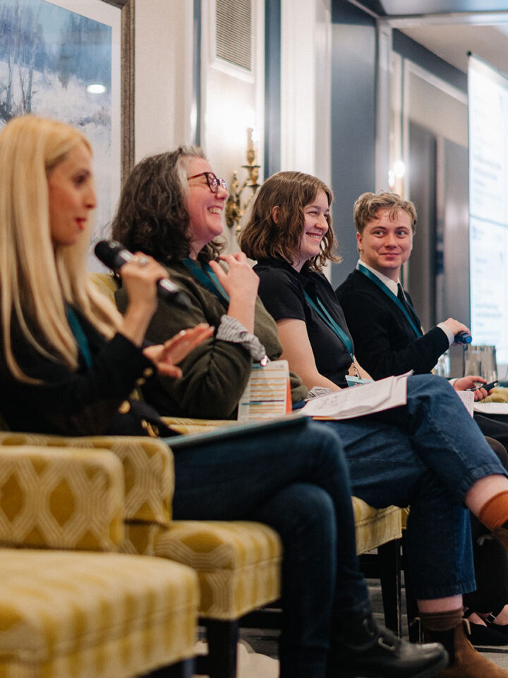 Speakers from the Young Caregivers panel sharing a moment of laughter on stage