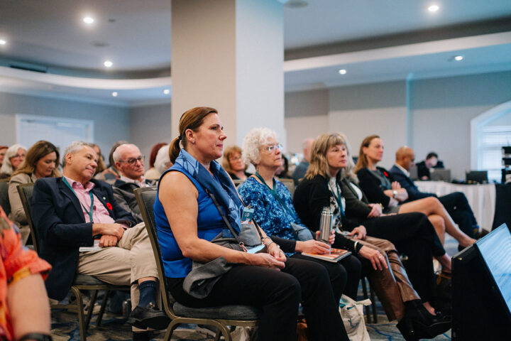Audience members seated at a panel