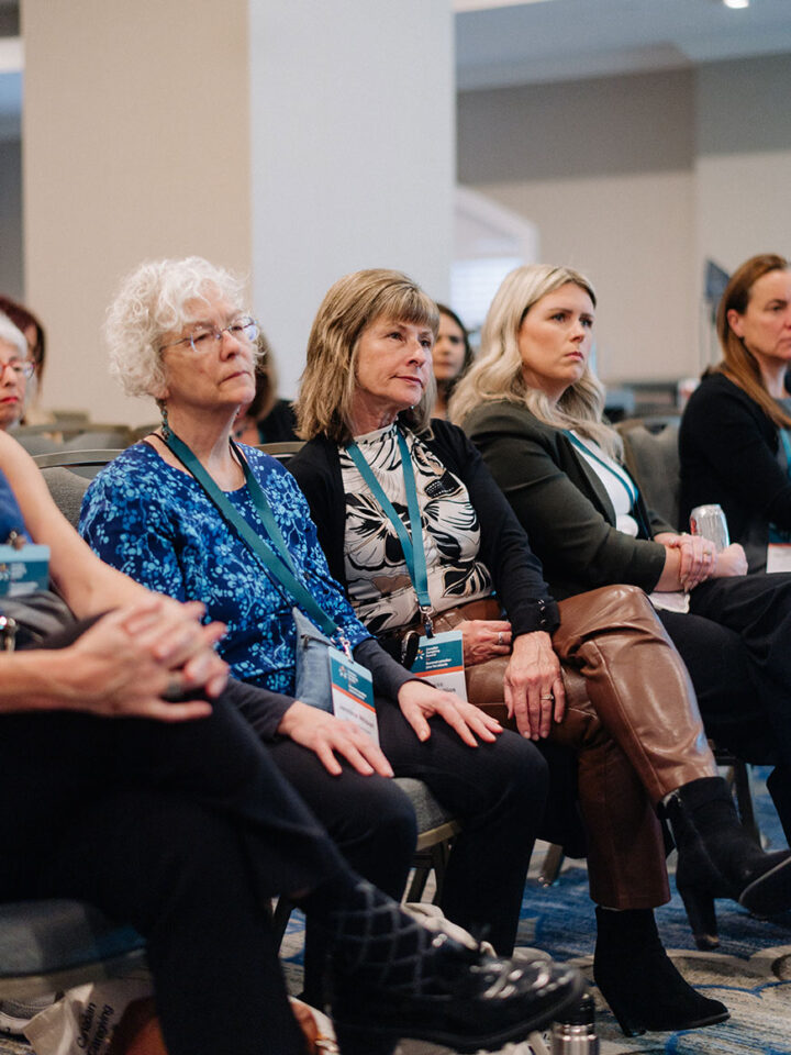 A row of attendees seated at a panel