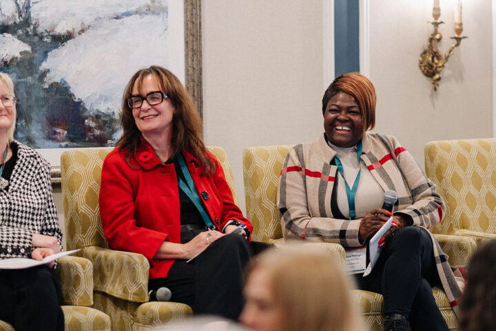 Dr. Fiona Deller and Fredrica Pottinger smiling on stage at the panel on home care.