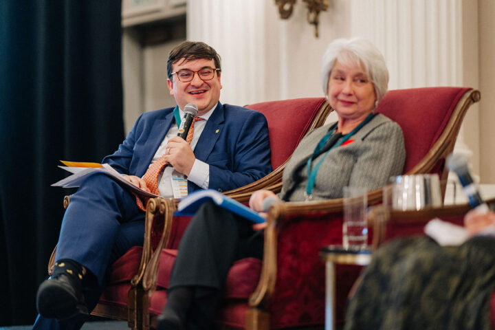 Daniel Nowoselski smiles while holding the microphone during the panel on financial security.