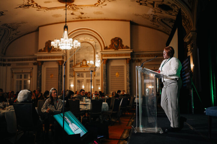 Care provider Fredrica Pottinger shares her story on stage to kick off day two of the Summit